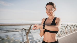 Woman checking her smartwatch while walking outdoors